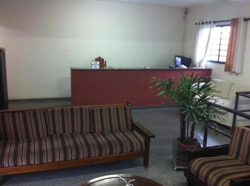 a waiting room with two couches and a reception desk at 50 Hotel in Extrema