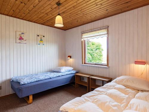 a bedroom with two beds and a window in it at 5 person holiday home in Roslev-By Traum in Sønder Thise