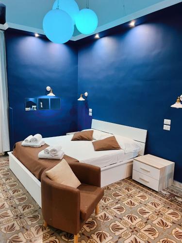 a bedroom with a large bed and a blue wall at DEAS B&B in Trani