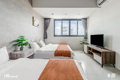 Ένα ή περισσότερα κρεβάτια σε δωμάτιο στο Penghu SunSea Hall