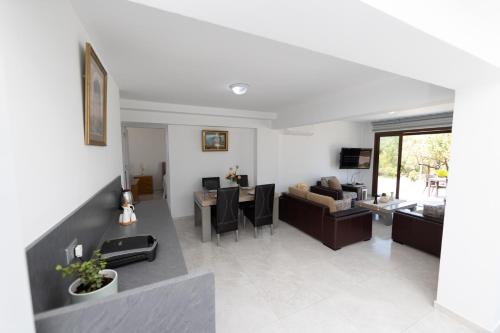 a living room with a couch and a table at Bellapais Apartments in Kérynia