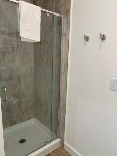 a bathroom with a shower with a glass door at Winzig Lodge in Lava Hot Springs