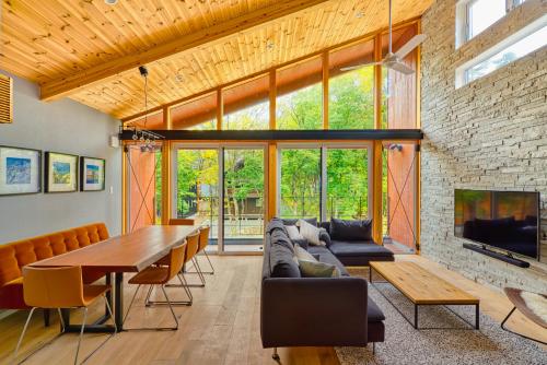 a living room with a couch and a table and a fireplace at Cherrywoods Place by Hakuba White Fox Company in Hakuba