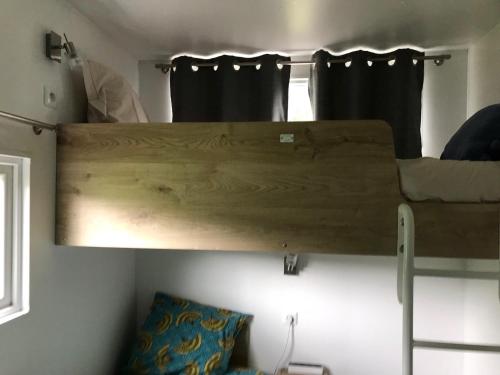 ajar view of a bunk bed in a room at L Orée Du Bois in Moncheux