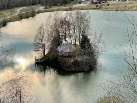 an island in the middle of a body of water at domaine des planesses in Ferdrupt