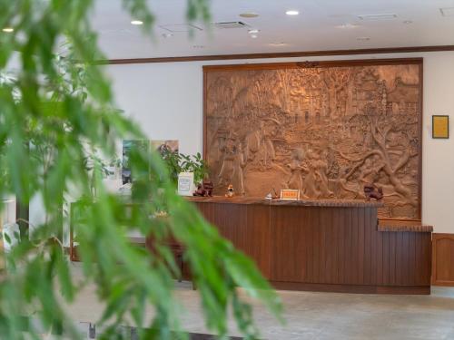 a large tapestry on the wall in a room at Ada Garden Hotel Okinawa in Kunigami