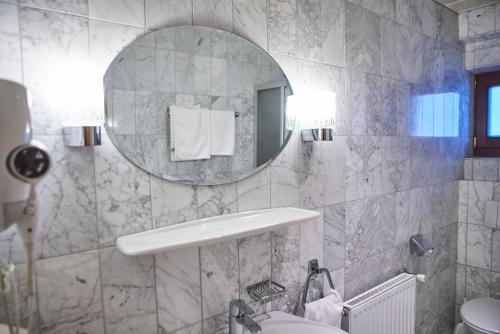 a bathroom with a sink and a mirror at Chalet Haider in Saalbach Hinterglemm