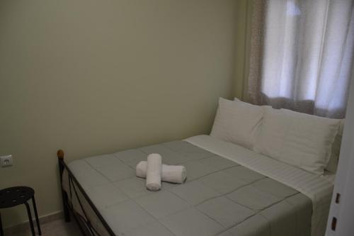 a white stuffed animal sitting on a bed at Frygano Apartments 1 in Oítilon