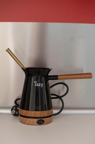 a black coffee pot sitting on top of a counter at Bungalow Episkopiko in Ioannina