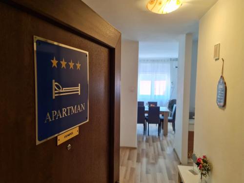 a door to a apartment with a sign on it at Apartment Pemper - Self check in and check out in Otočac