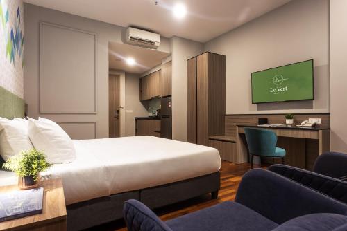 a hotel room with a bed and a desk at Le Vert Boutique Hotel in Genting Highlands