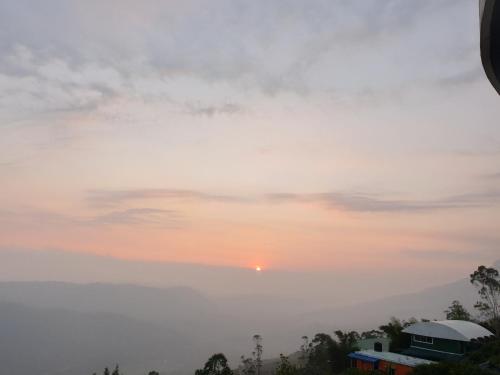 a view of the sunset from the balcony of our house at Seekend Holidays Munnar in Chinnakanal