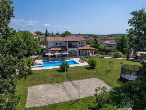 an aerial view of a house with a yard at Picturesque Villa in Verteneglio with Pool in Brtonigla
