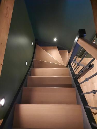 a staircase in a building with a green ceiling at Le Petit Bégou in Saint-Auban-dʼOze