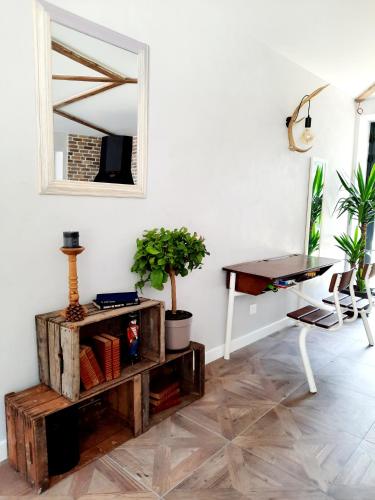 a room with a table and a mirror and a desk at Le Petit Bégou in Saint-Auban-dʼOze