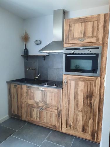 a kitchen with a sink and a stove at Le Petit Bégou in Saint-Auban-dʼOze