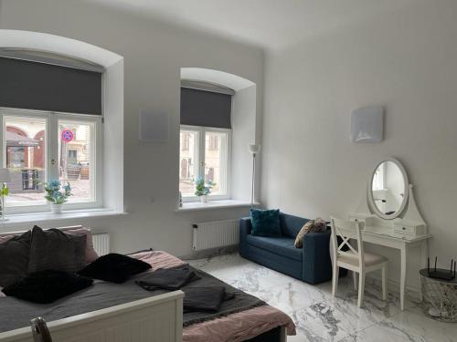 a bedroom with a bed and a mirror and a chair at Riga Center Apartment in Old Town in Rīga