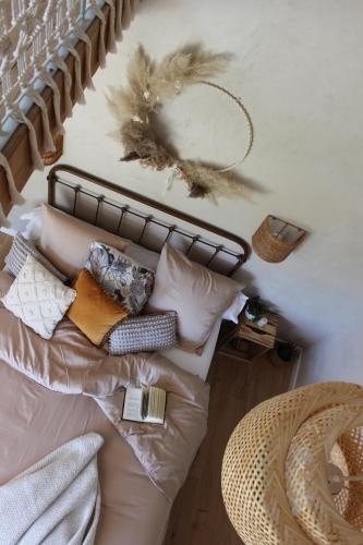 a living room with a couch with pillows and a wreath at Le Petit Bégou in Saint-Auban-dʼOze