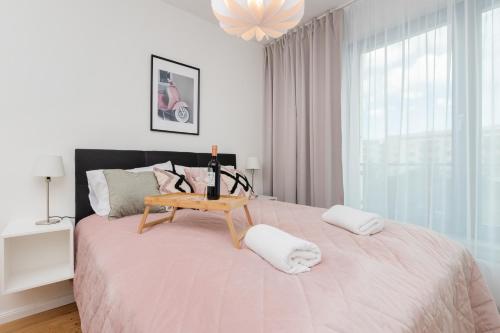 a bedroom with a large bed with a table on it at Apartament VESPA Beach Nearby by Renters in Gdynia