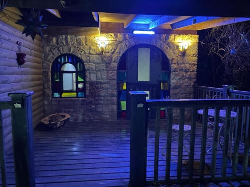 a night shot of a porch with lights on at צימר מאיה in Ani'am
