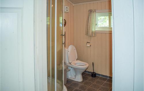 uma casa de banho com um WC e uma janela em Haugholmen em Bandaksli