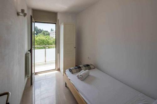 Habitación blanca con cama y ventana en Apartamento con parking privado en Girona, en Girona