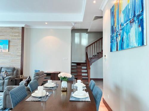 a living room with a table and blue chairs at Fairview Luxury Apartments in Dar es Salaam