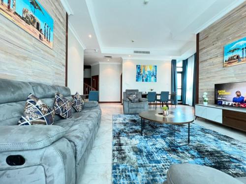 a living room with a couch and a table at Fairview Luxury Apartments in Dar es Salaam