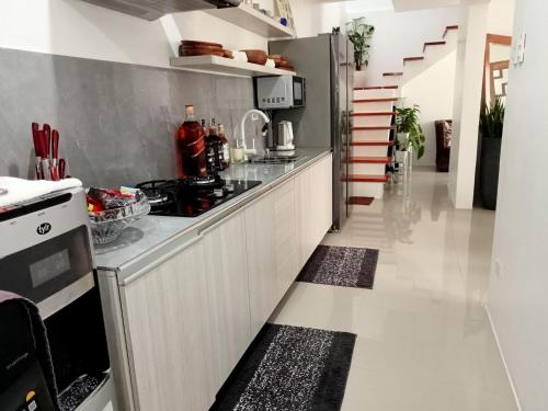 a kitchen with a stove and a counter top at Natalie's Villa in Iloilo City