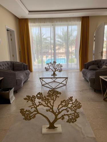 a living room with a tree in the middle of it at Farm Lebanon in Abu Dhabi