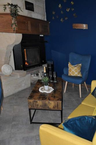 a living room with a couch and a fireplace at Les Antonins in Marville