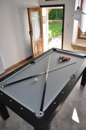 a pool table in a living room with afits at Les Antonins in Marville