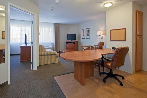 a room with a table and chairs and a living room at Candlewood Suites Nogales by IHG in Nogales
