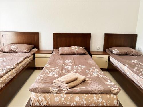 a room with two beds and two towels at Majap hostel in Ohrid