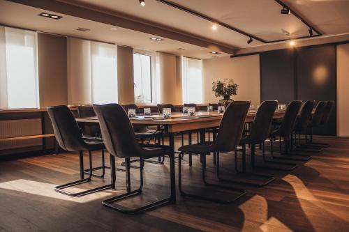 a conference room with a long table and chairs at Arivo Forchheim in Forchheim