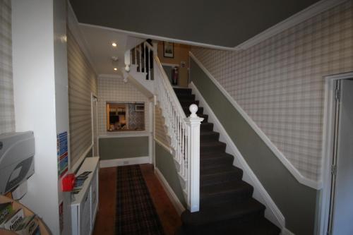 a staircase in a home with white and gray stairs at The Sunningdale in Bamburgh