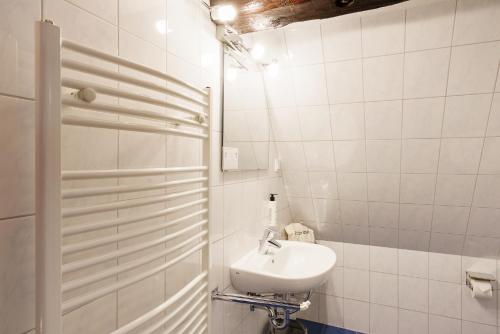 a white bathroom with a sink and a mirror at Hotel Waren-Alte Warener Zeitung in Waren