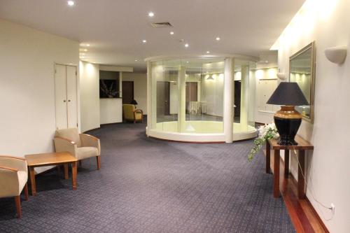 a lobby with chairs and a room with a mirror at Hotel Santa Maria in Alcobaça