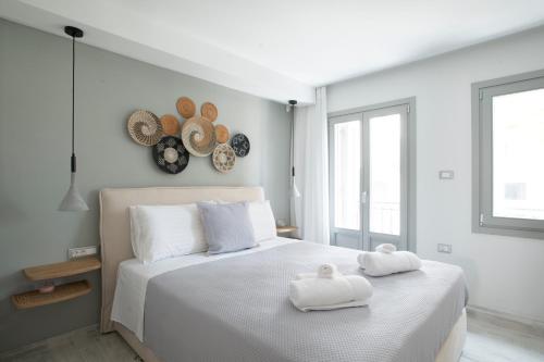 a bedroom with a white bed with towels on it at Pilos Sunrise Loft in Pylos