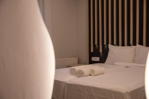 two beds with towels on them in a bedroom at SithoniaRS Luxury Apartment 2nd Floor with Sea View in Neos Marmaras