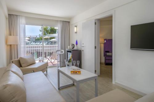 a living room with a couch and a table at Sol House The Studio - Calviá Beach - Adults Only in Magaluf