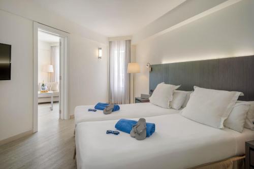 a hotel room with two beds with teddy bears on them at Sol House The Studio - Calviá Beach - Adults Only in Magaluf