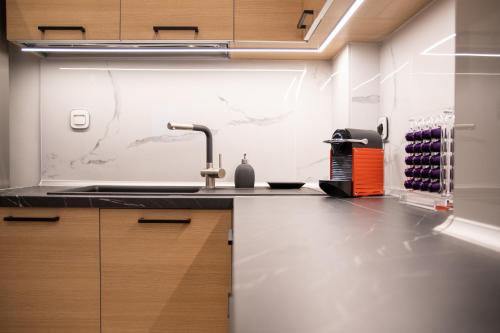 a kitchen with a sink and a counter top at SithoniaRS Luxury Apartment 2nd Floor with Sea View in Neos Marmaras