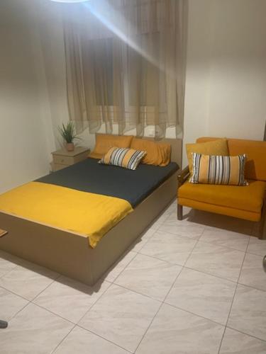 a bed and a couch in a room at Elin Loft Rooms in Flogita