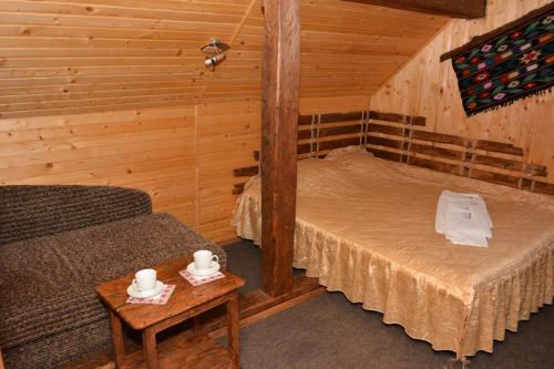 a room with a bed and a couch in a cabin at SKI Xata in Bukovel