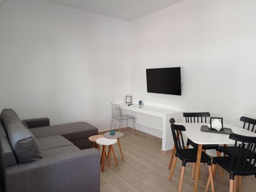 a living room with a couch and a table at Partcon Apartment A in Neoi Epivates