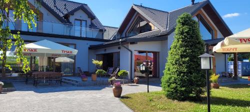 a house with a fire hydrant in front of it at Villa & Gospoda Krakowska in Kobiernice