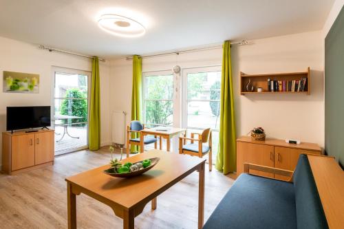 a living room with a couch and a table at IDA Arendsee in Arendsee
