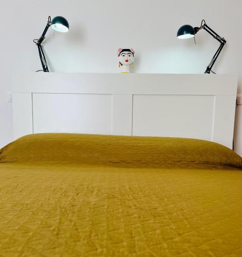 a bedroom with a bed with two lamps on it at B&B letterario Palazzo Pistocchi in Teramo