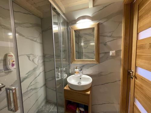 a bathroom with a sink and a shower at Anastasia’s Apartment in Sinarádes